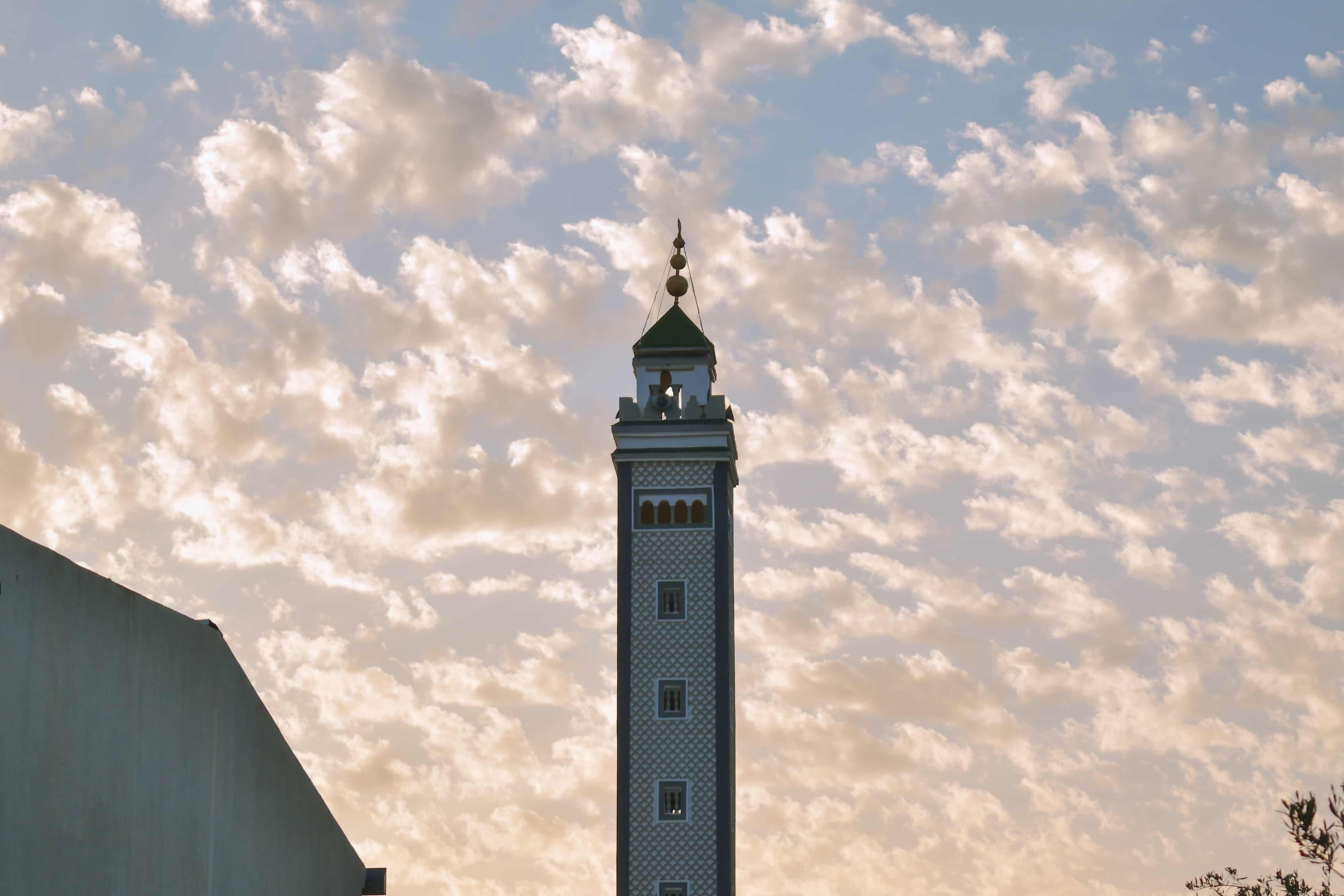 Golden hour clouds behind a mosque tower