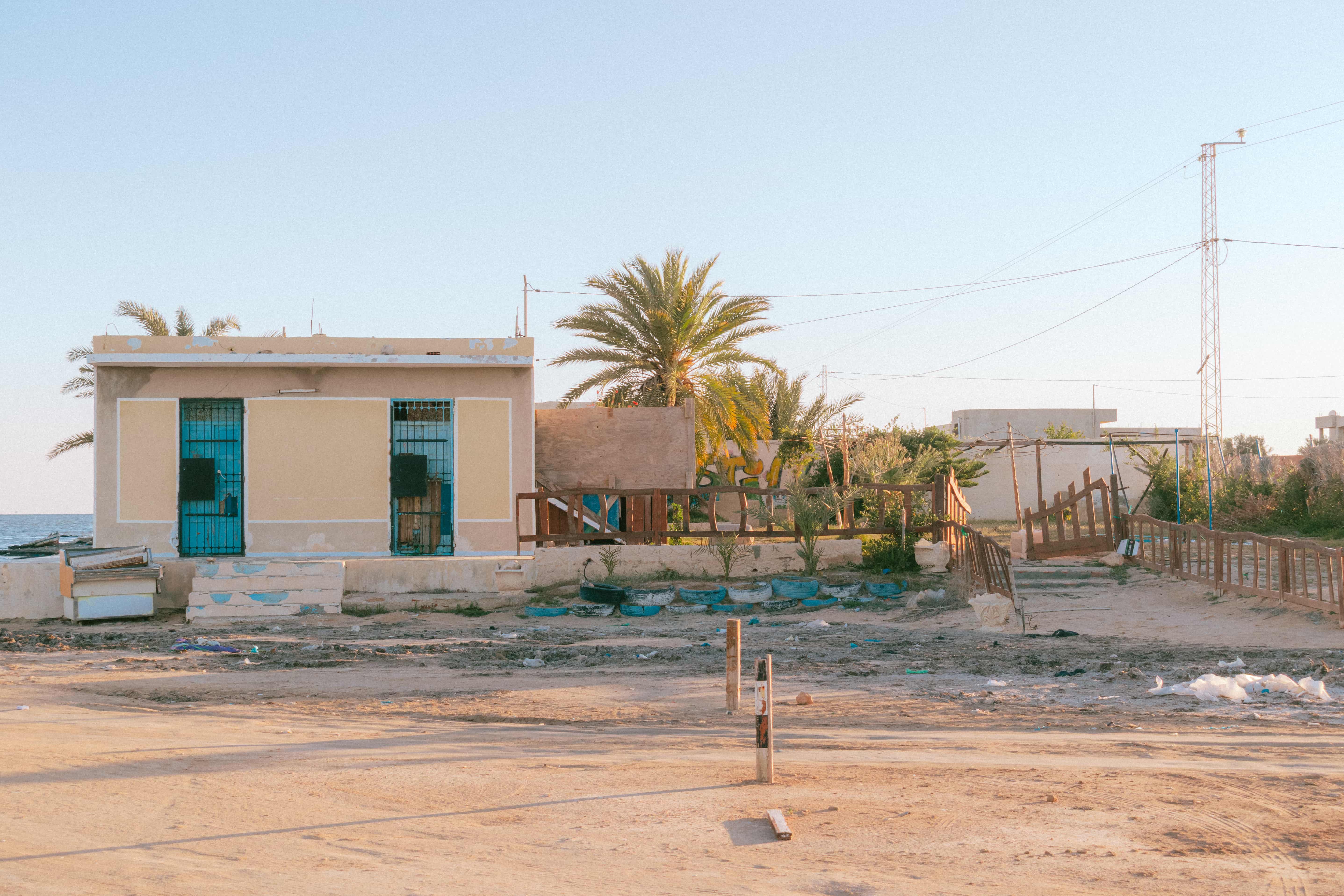 Coastal building, palm trees, golden light