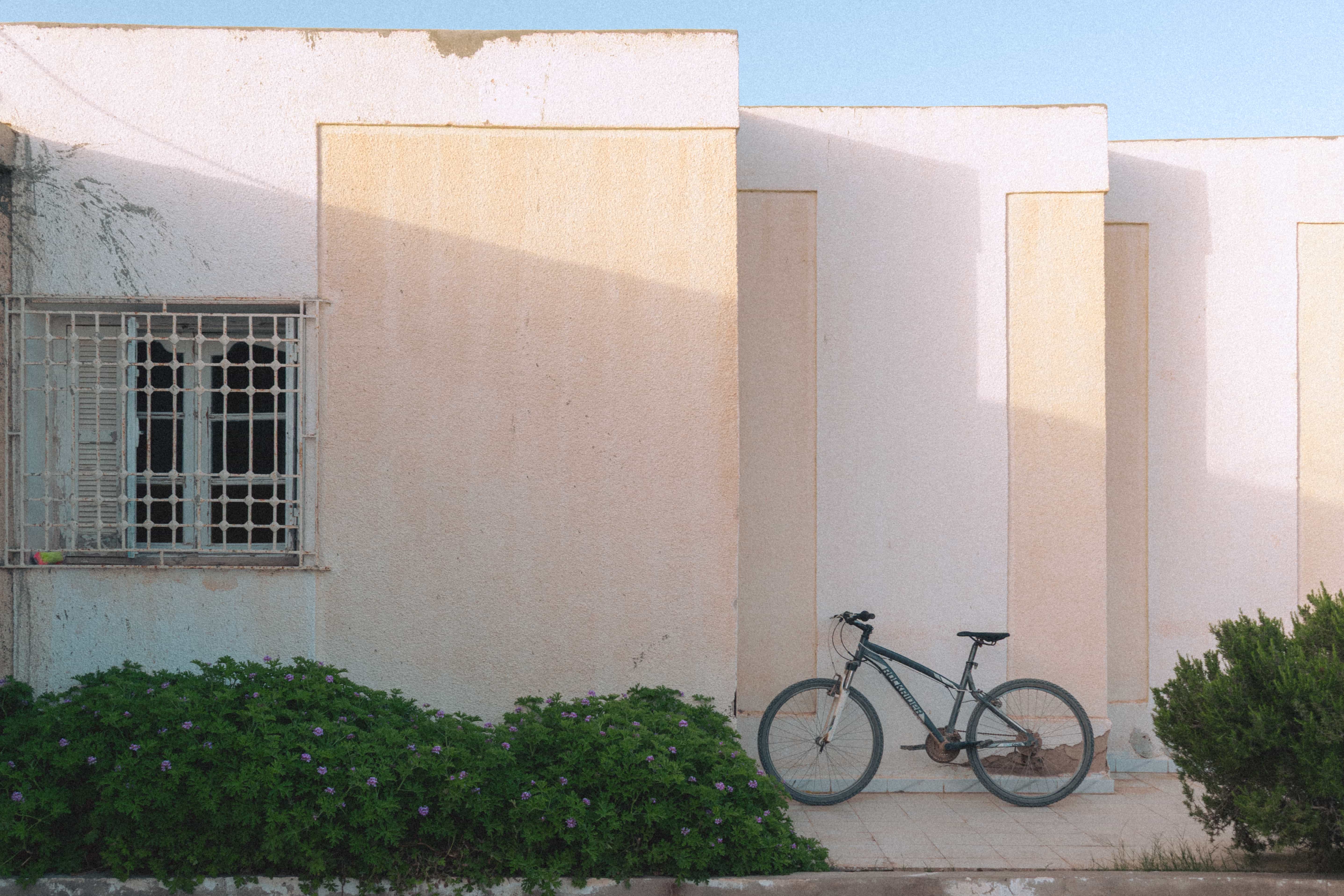 Bicycle leaning against a warm sunlit wall, Sfax